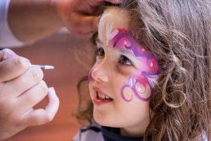 A girl has her face painted in California, USA