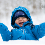 Baby laughing in snow