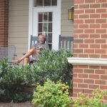 man reading on front porch